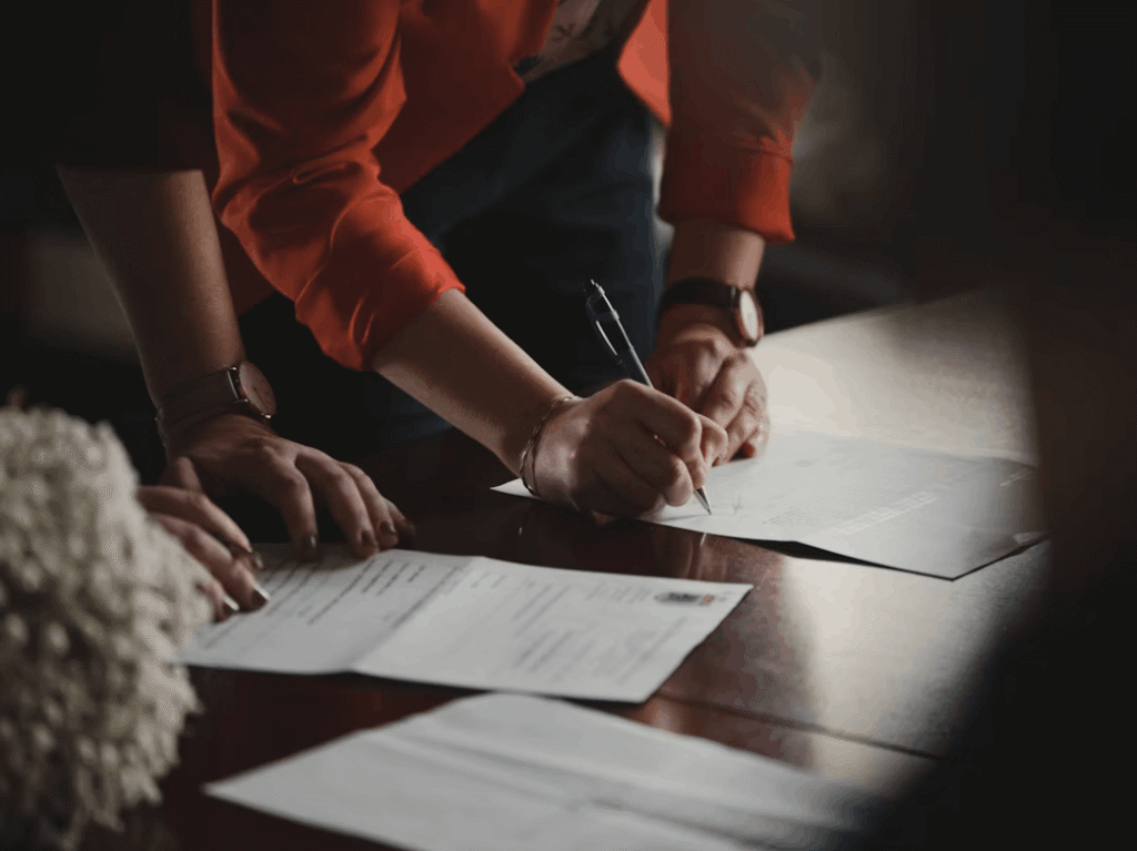 hand writing on a paper on top of a desk