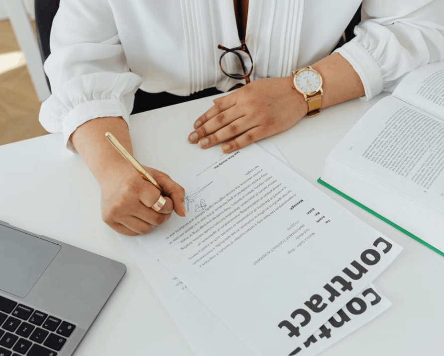 lady writing a contract